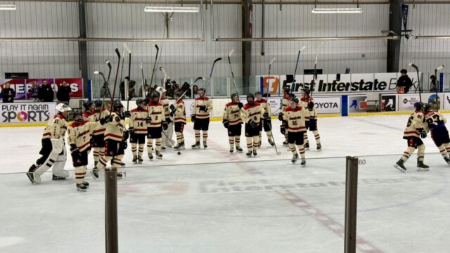 Americans raise their sticks in celebration in Saturday's 4-3 overtime win over Helena.